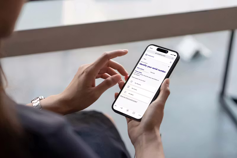 A person holds a smartphone displaying the "Enquirus" website.